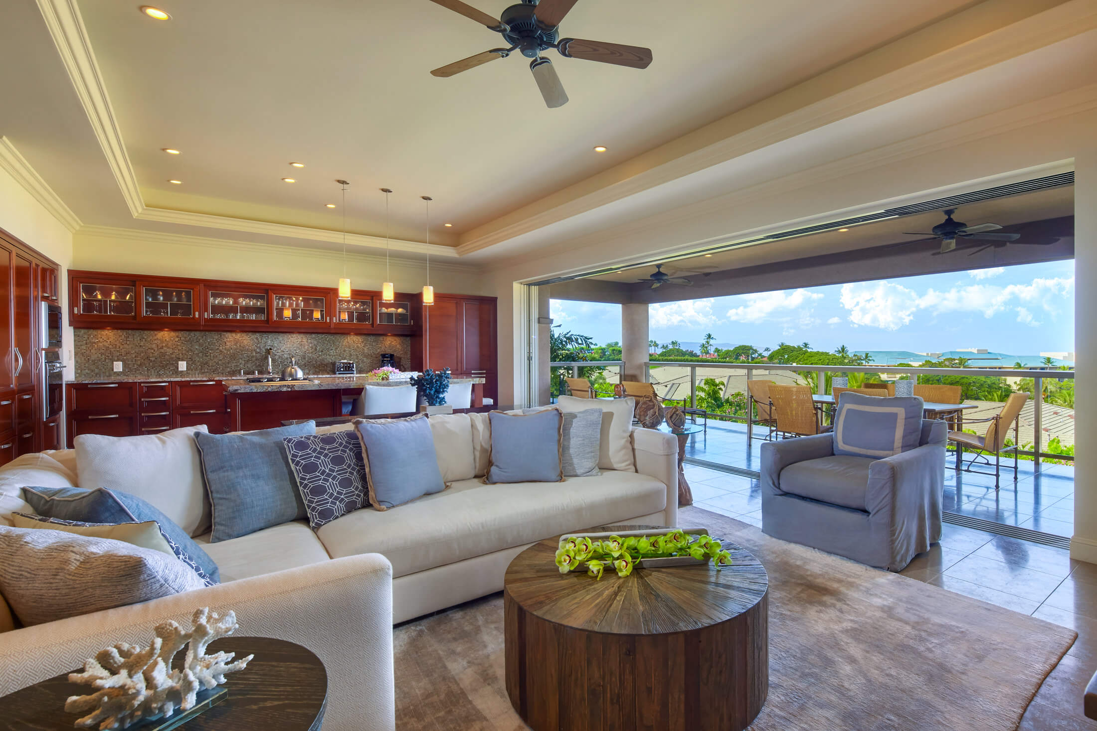 living room seating area in Ho'olei Villas with full wall of windows give view of outside