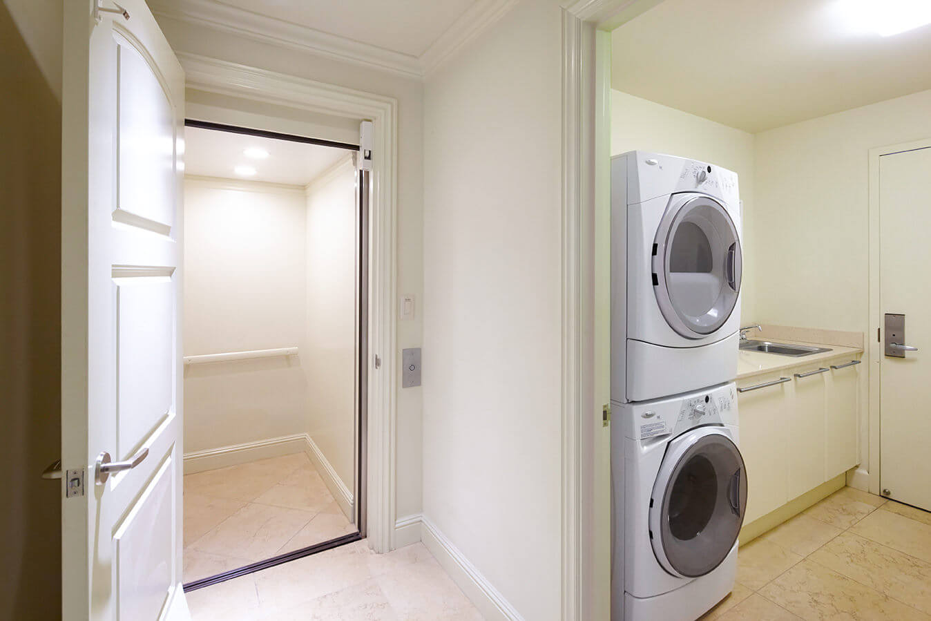 interior view of laundry room with stacked washer and dryer in the Ho'olei Villa