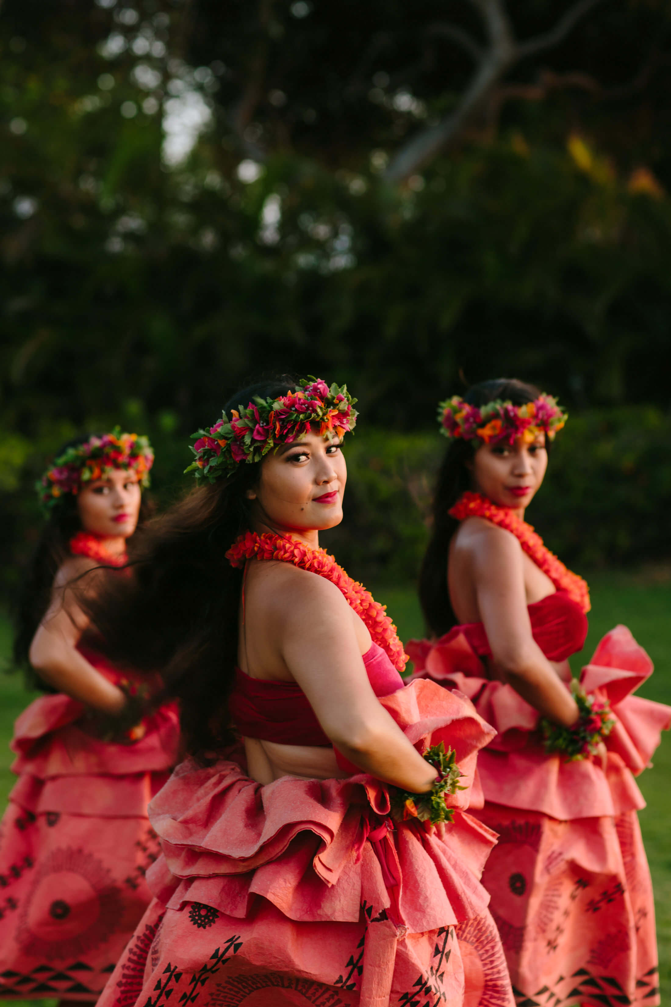 a group of women in red look over their shoulders