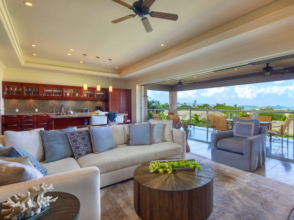 living room seating area in Ho'olei Villas with full wall of windows give view of outside