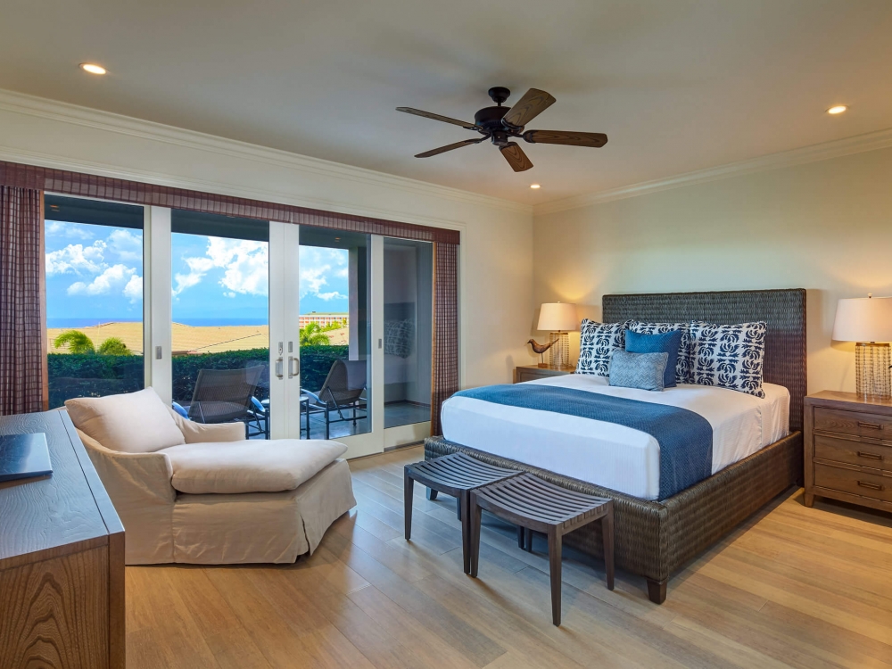 king bed and seating area in Ho'olei Villas with patio doors give view of outside
