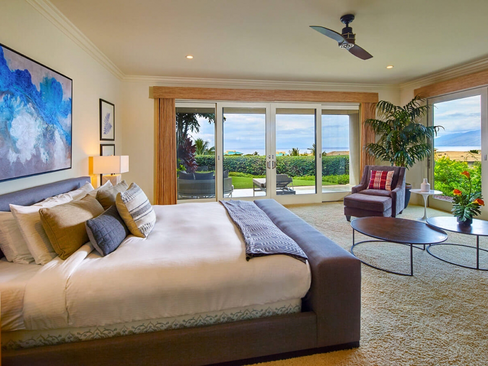 king bed and seating area in Ho'olei Villas with patio doors give view of outside