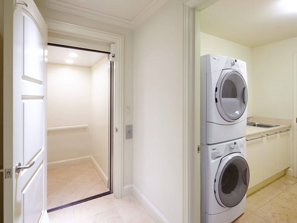 interior view of laundry room with stacked washer and dryer in the Ho'olei Villa