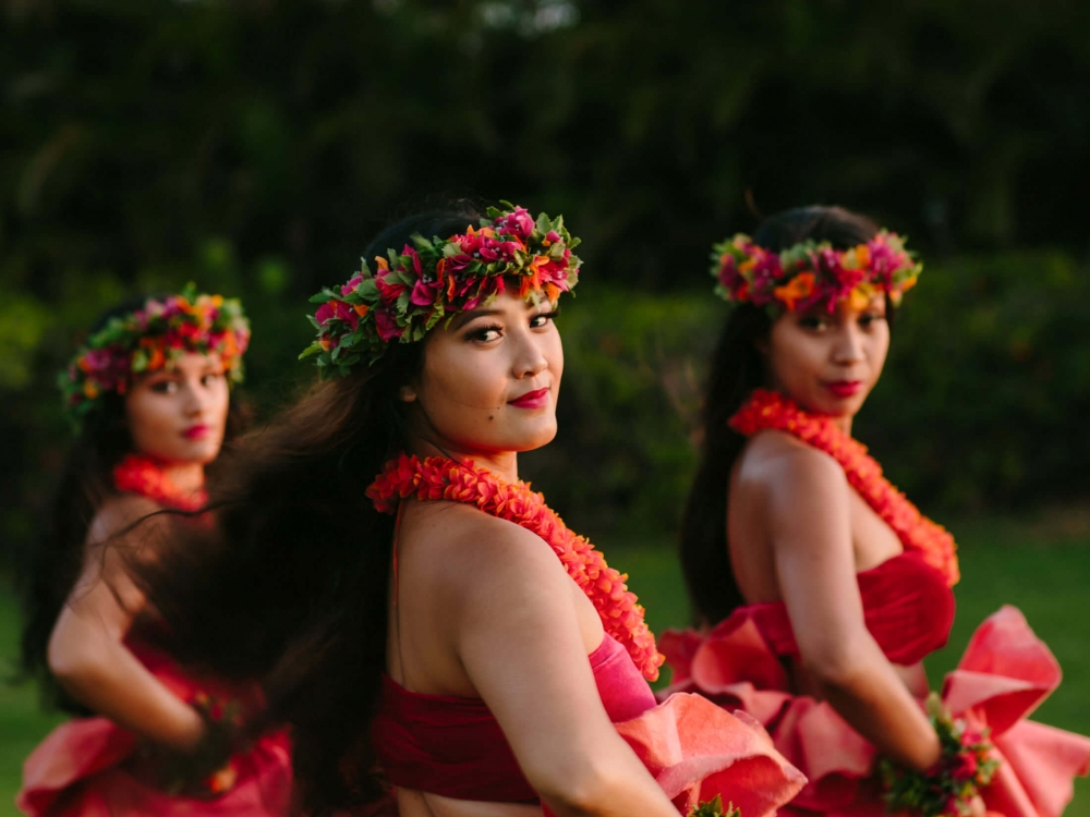 a group of women in red look over their shoulders