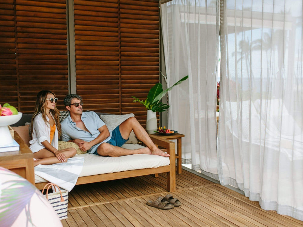 a couple sits in a cabana 