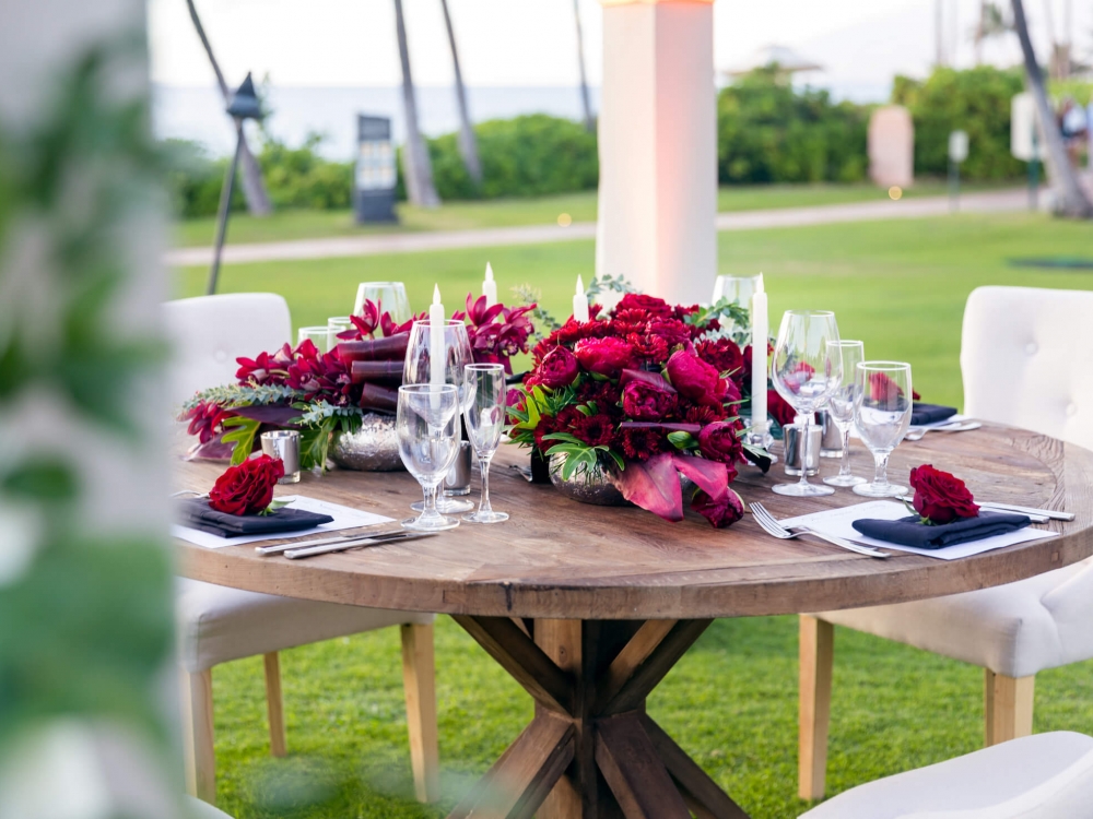 chairs sit around wooden table with floral centerpiece