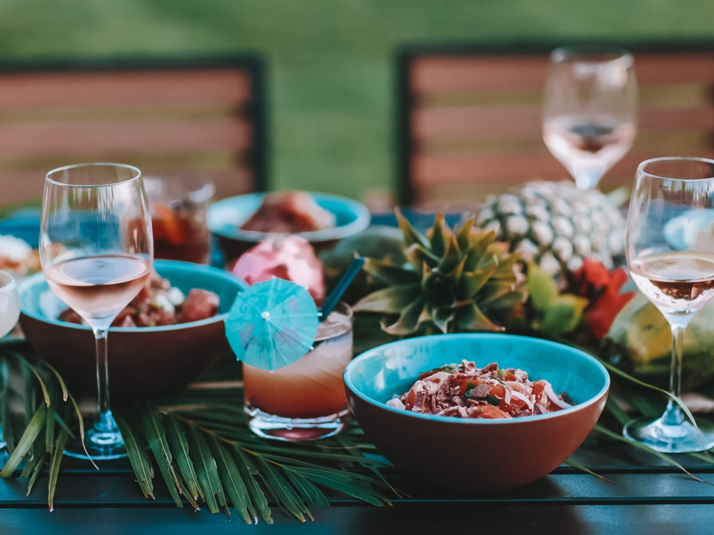 a table covered with food, flowers, and table settings