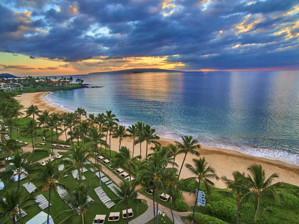 A sunset over a beach from a bird's eye view