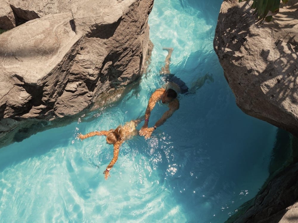 Two people swimming in the lazy river