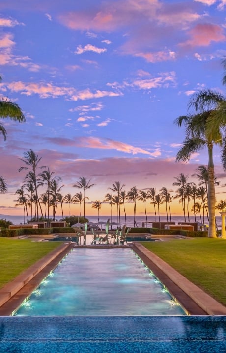 water feature stretches out into the grounds of Grand Wailea resort with lines of palm tress on either side