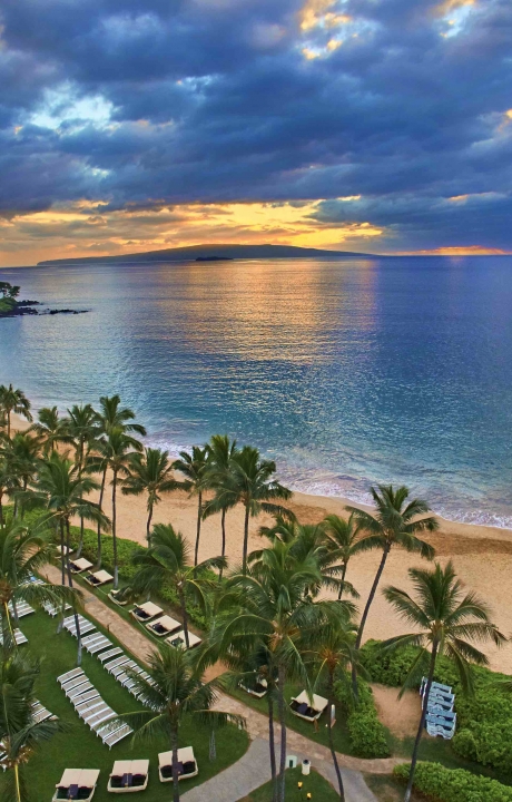 A sunset over a beach from a bird's eye view