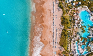 aerial view of Grand Wailea resort and pool with beach and ocean to the left 