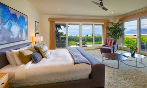 king bed and seating area in Ho'olei Villas with patio doors give view of outside