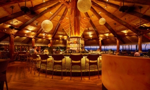 interior view of brightly lit humuhumunukunukuapua'a restaurant at dusk