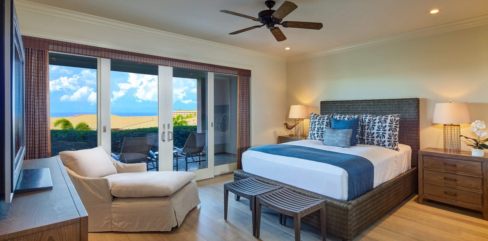 king bed and seating area in Ho'olei Villas with patio doors give view of outside