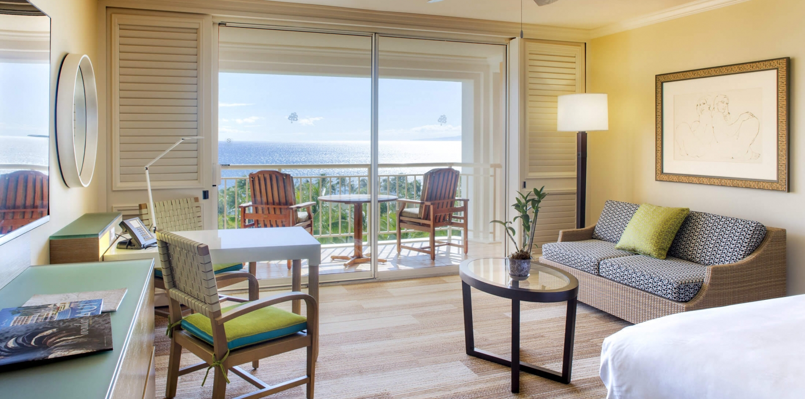 bed and seating area in King Oceanview room with patio doors give view of outside