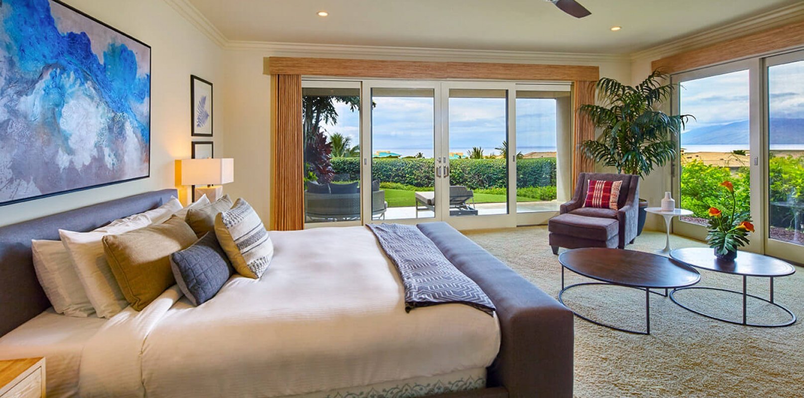 king bed and seating area in Ho'olei Villas with patio doors give view of outside