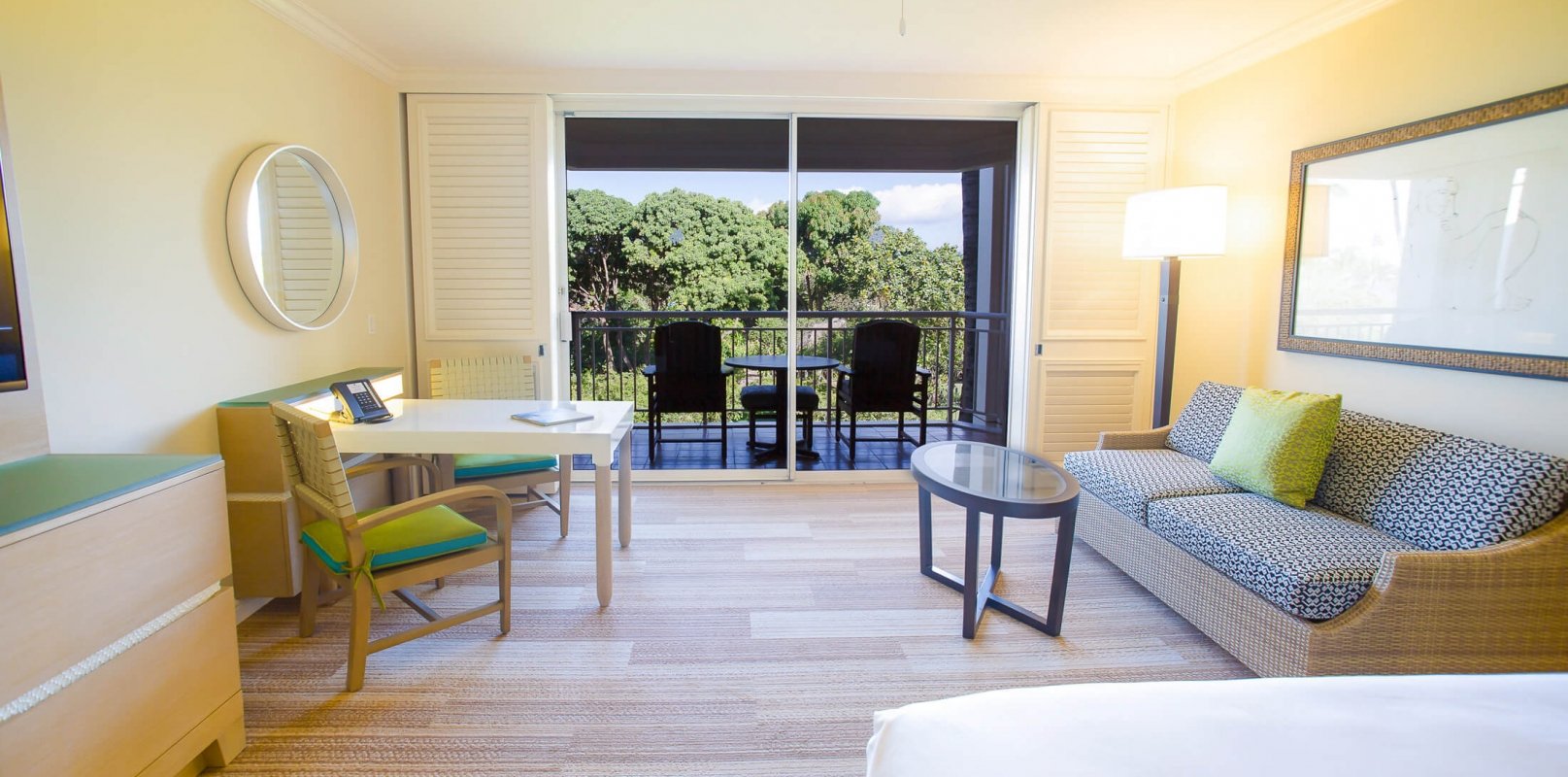 bed and seating area in King Garden view room with patio doors give view of outside