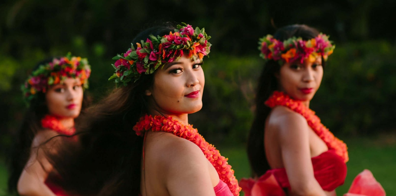 a group of women in red look over their shoulders