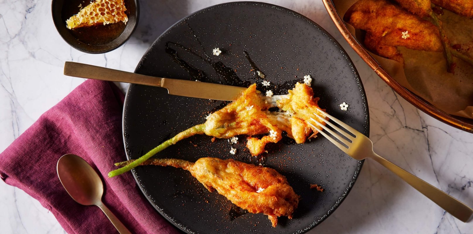 squash blossom on black plate