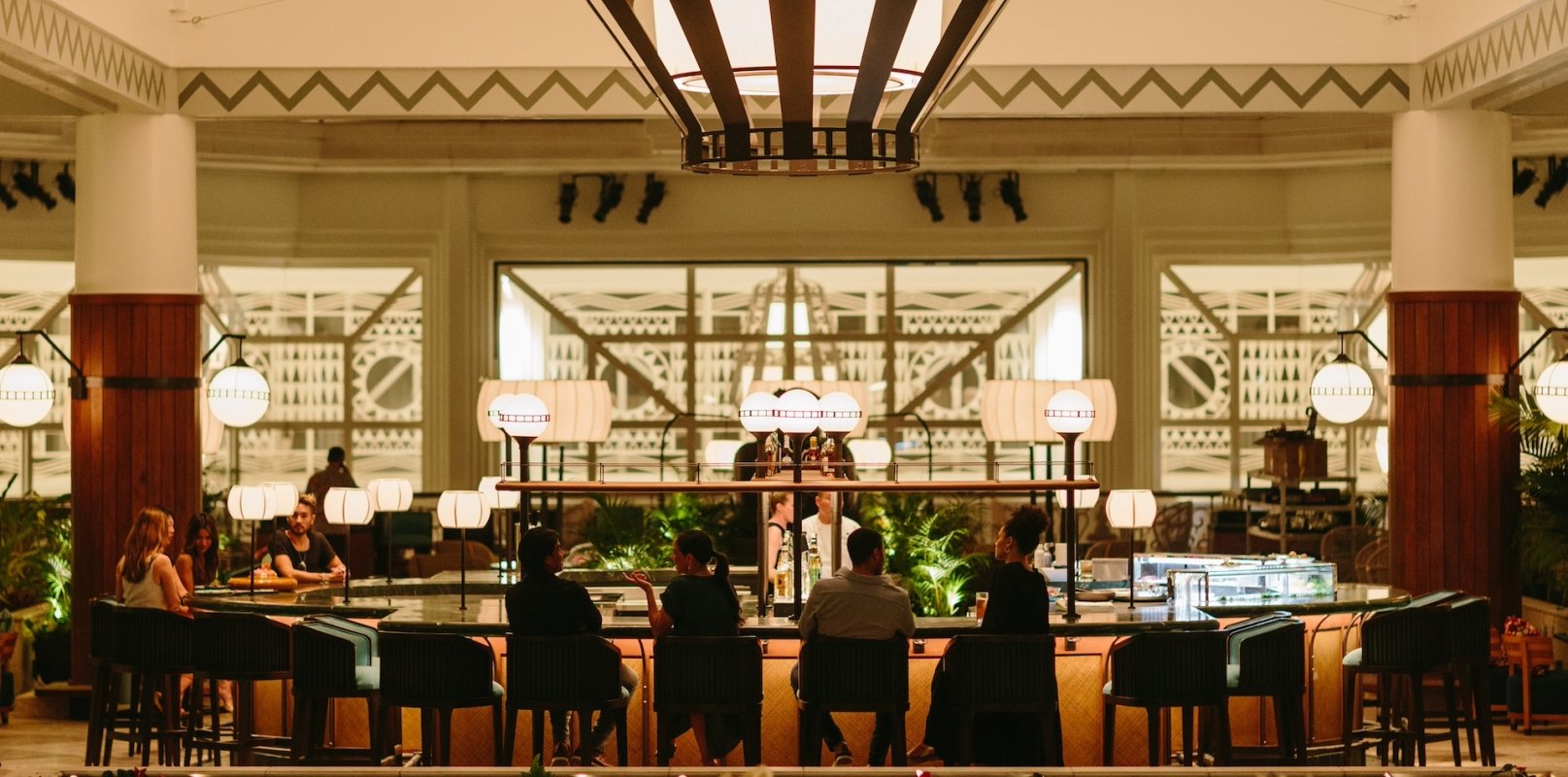 A large restaurant dining room with large communal tables and wide windows