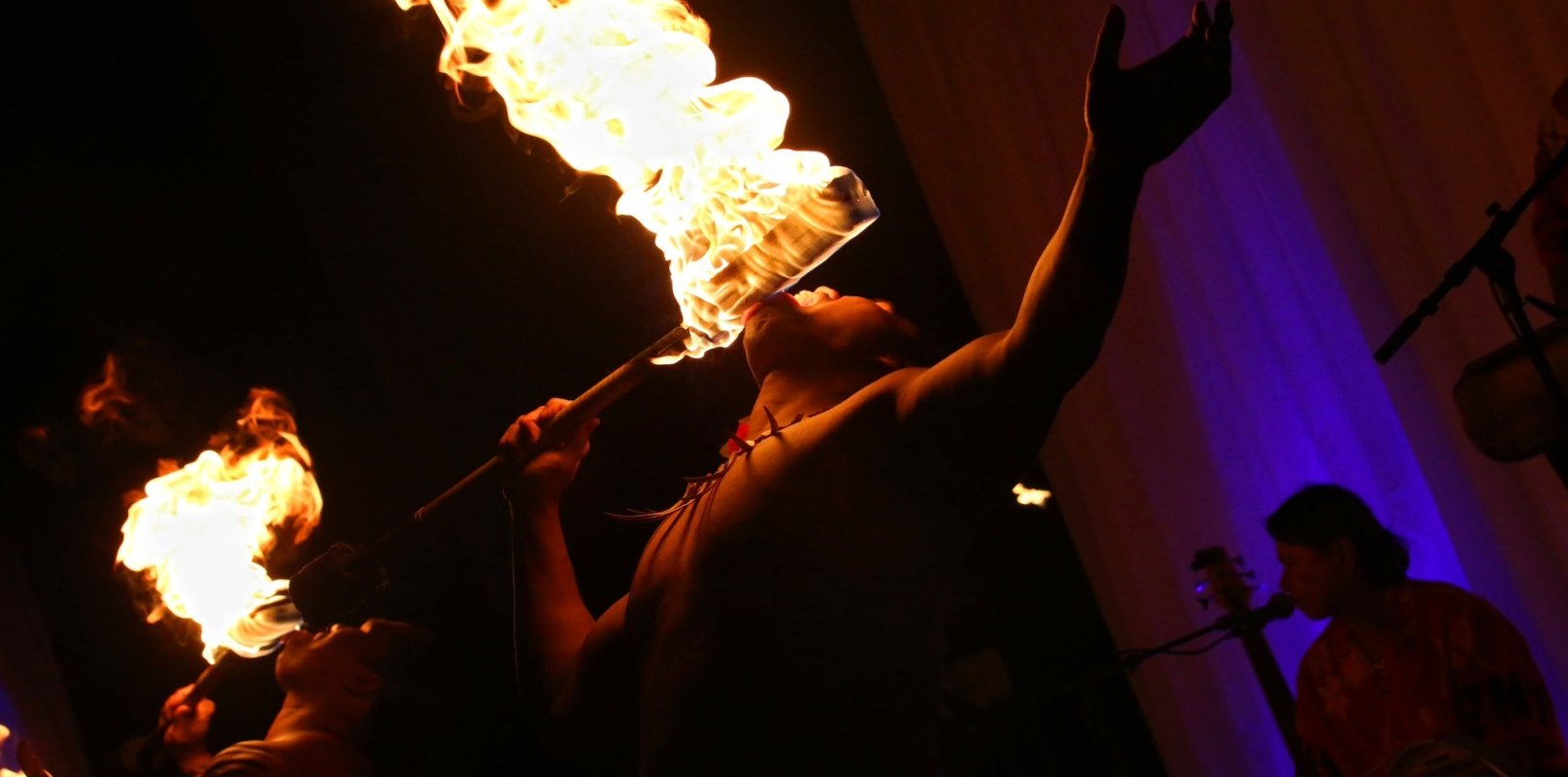 A group of fire breathers perform at a Luau