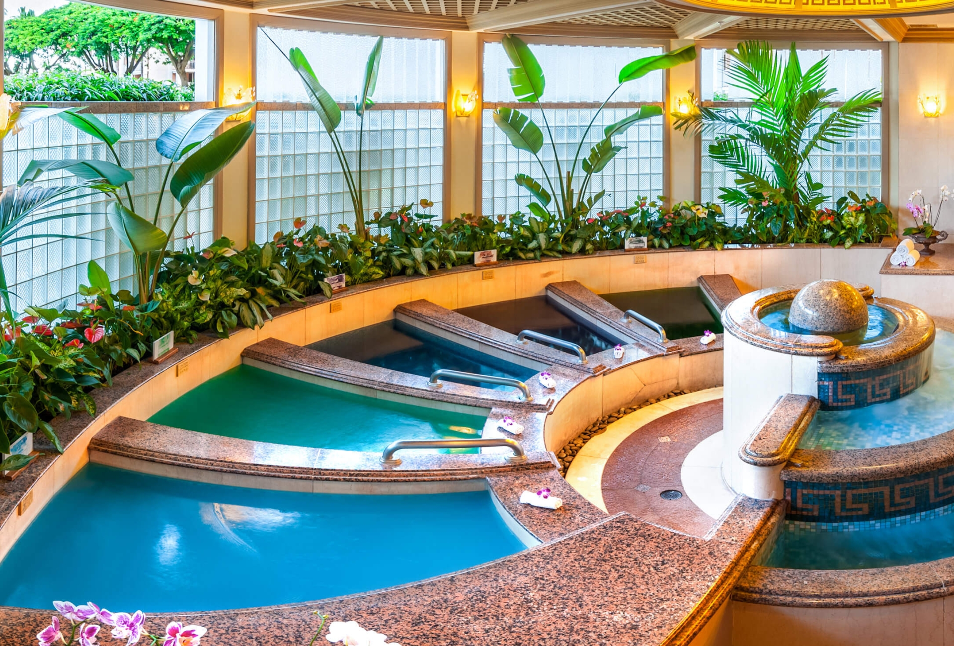a shell-shaped pool inside the spa grande overlooks thr Grand Wailea resort