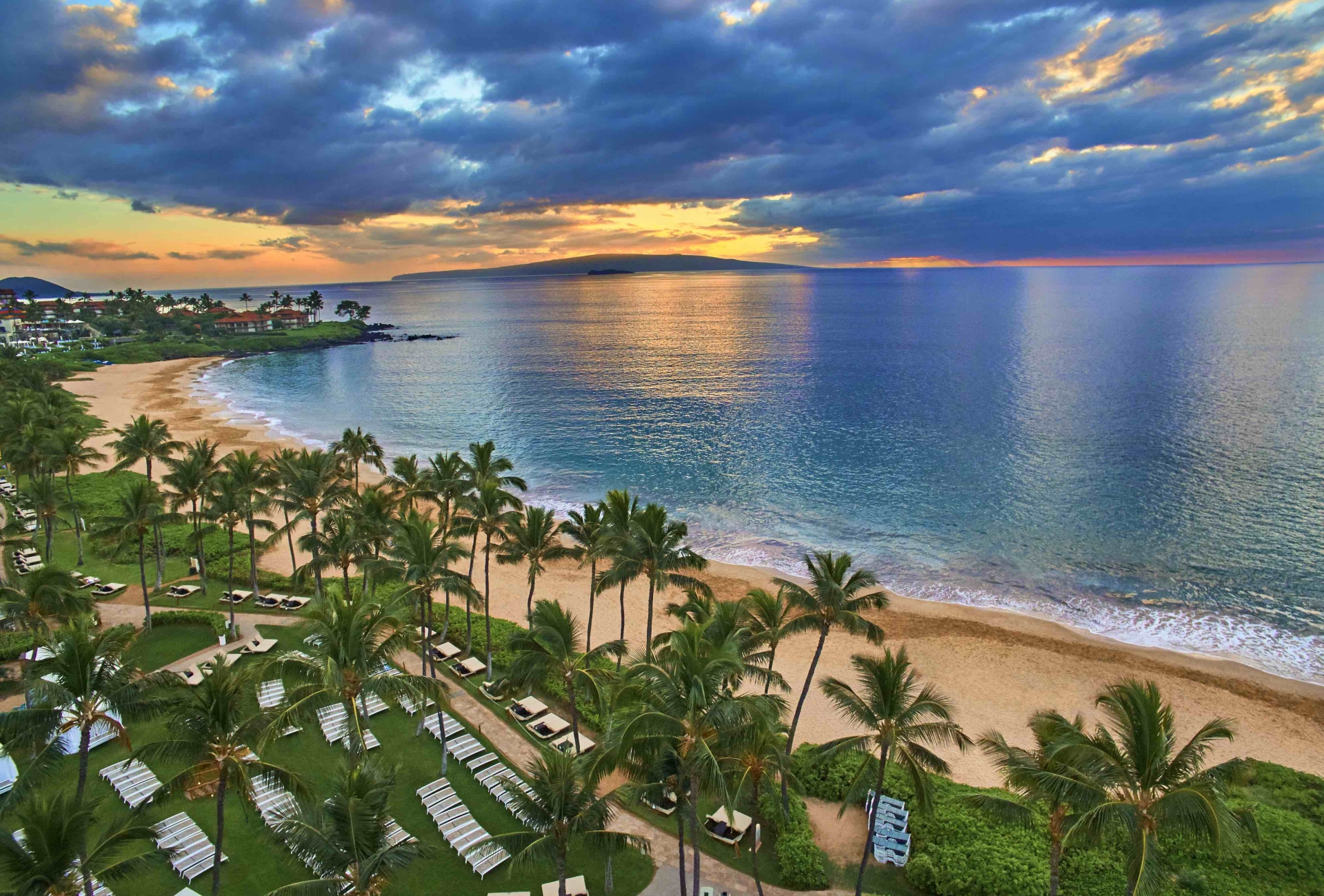 A sunset over a beach from a bird's eye view