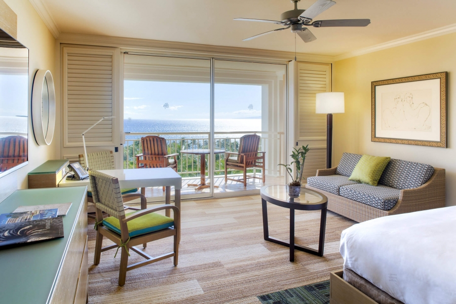 king bed and seating area in Grand Wailea room with patio doors give view of outside