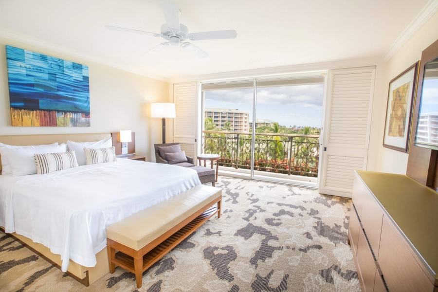 king bed and seating area in Napua Club Nani Suite with patio doors give view of outside