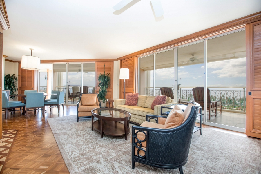 living room seating area in Napua Club with full wall of windows give view of outside