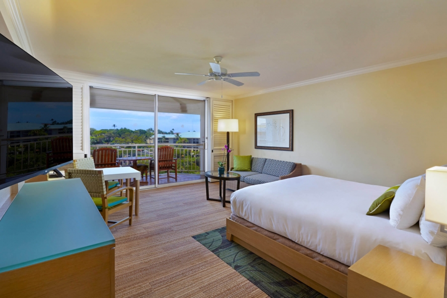 bed and seating area in King Terrace room with patio doors give view of outside