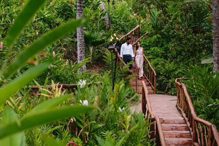 Couple walking down steps in Grand Wailea garden